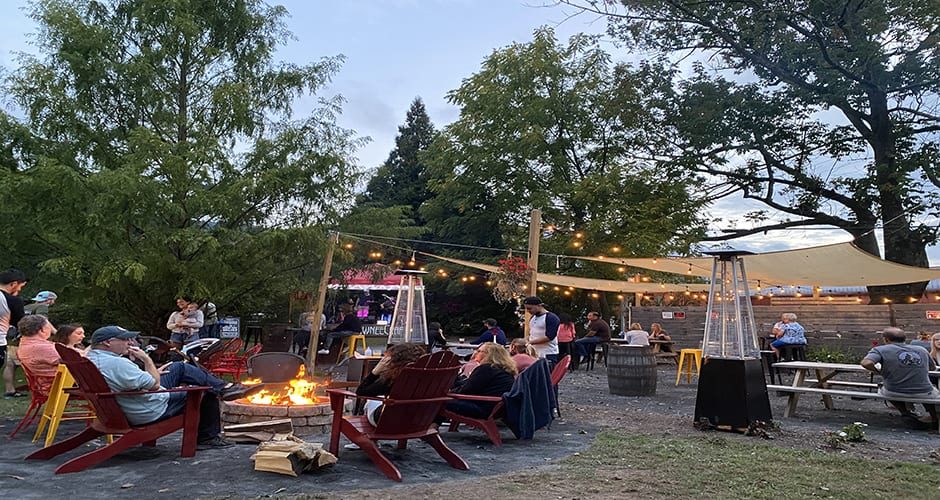 People in beer garden around fire pit