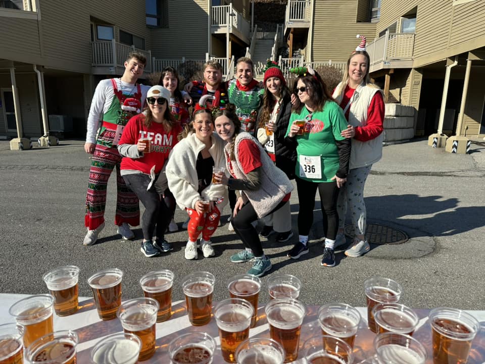 Group of festive runners in front of table of beer glasses